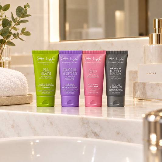 A Dr. Lipp Travel Pack containing four squeeze tubes of hair and skin care products in lime green, purple, pink, and dark gray, displayed on a pink and white cardboard tray.